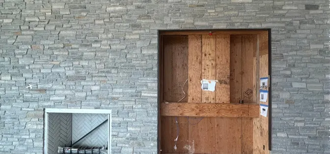 Stacked stone interior wall with wood door