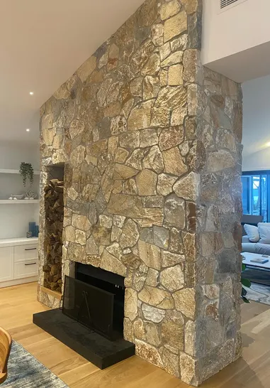 Natural fieldstone fireplace surround in a living room