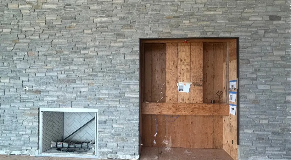 Interior stone accent wall with stacked natural stone in a modern home