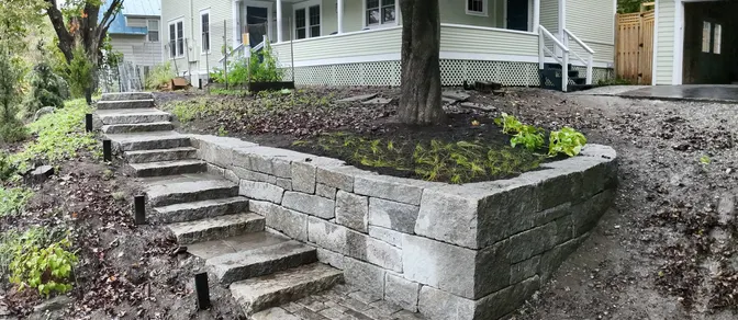 Natural stone steps and retaining wall in a landscaped yard