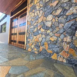 Fieldstone Veneer Wall Beside Wood Garage Doors, photo 3