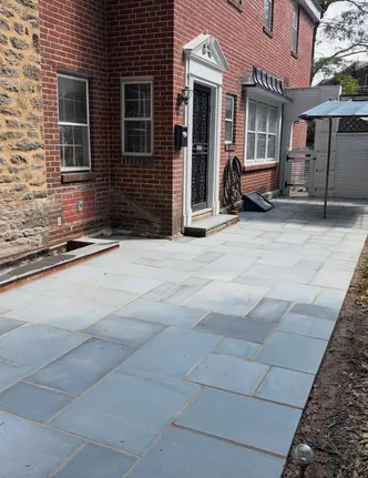 Rectangular Bluestone Patio Beside a Brick Home