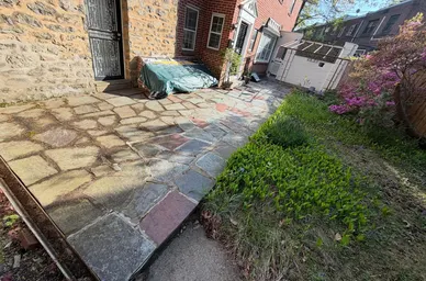 Rectangular Bluestone Patio Beside a Brick Home detail
