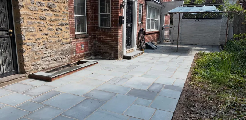 Rectangular Bluestone Patio Beside a Brick Home
