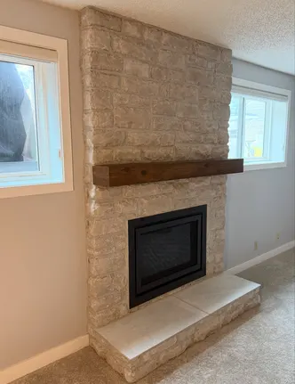 Stacked Stone Fireplace with Timber Mantel