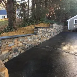 Stacked Stone Retaining Wall Along a Driveway, photo 1
