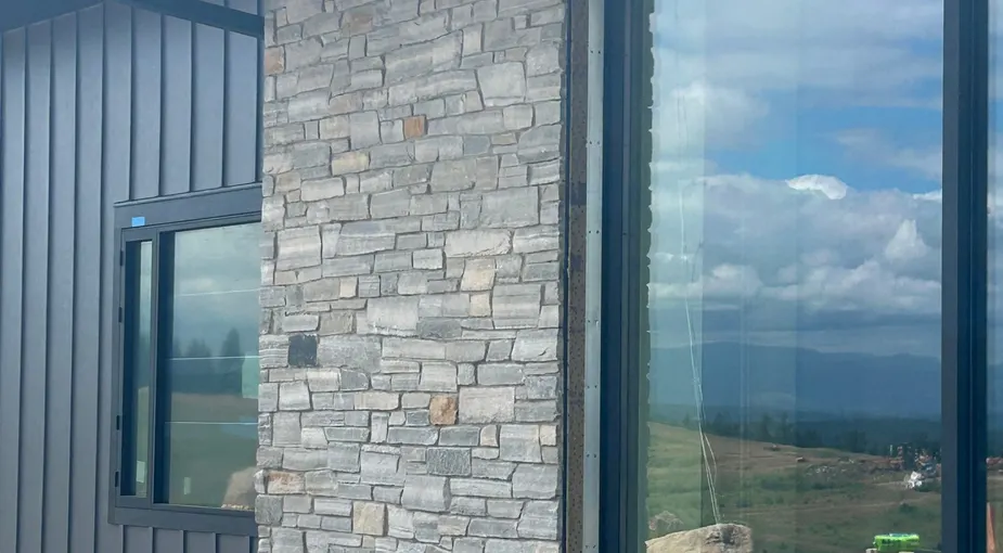 Light quartzite-tone stacked stone on an exterior column