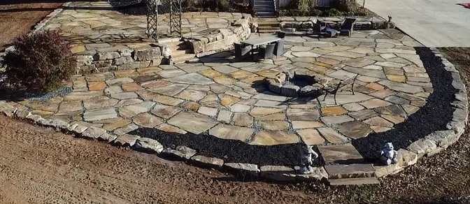Flagstone patio with a stone fire pit