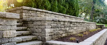 Stone retaining wall with built-in steps