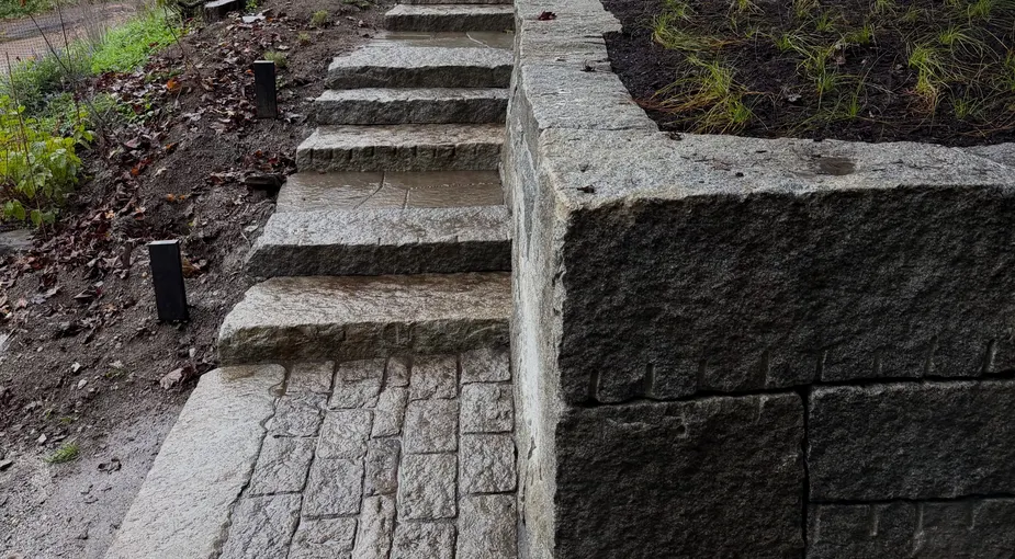 Natural stone steps installation leading up a landscaped slope