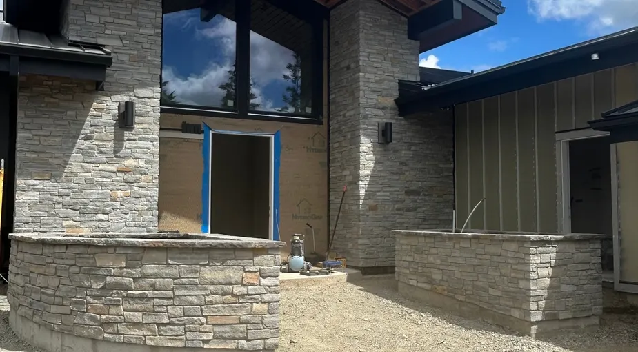 Stone veneer installation on the exterior of a modern San Diego-style home