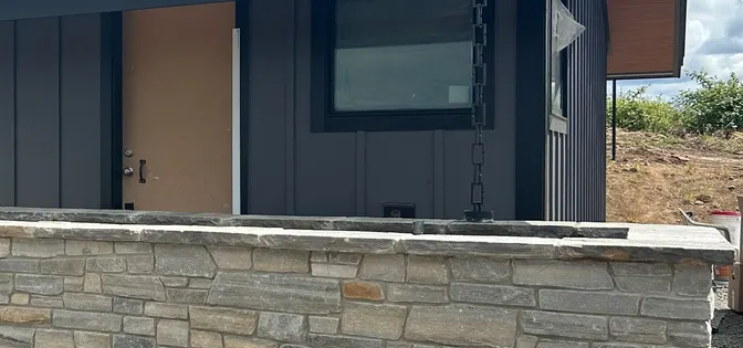 Stacked stone veneer wall on a modern home exterior